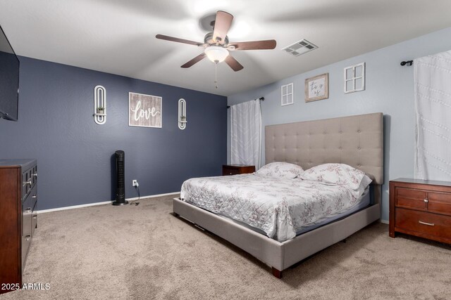 carpeted bedroom featuring baseboards, a ceiling fan, and visible vents