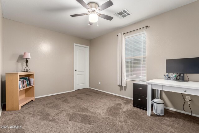 home office with carpet floors, visible vents, a ceiling fan, and baseboards
