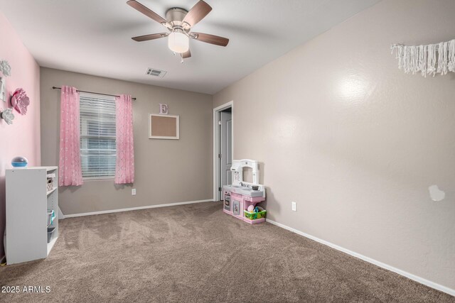 playroom with ceiling fan, carpet floors, visible vents, and baseboards