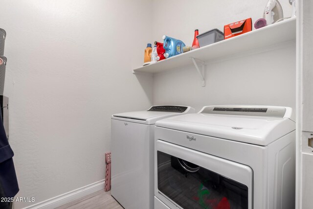 laundry area with independent washer and dryer, baseboards, and laundry area