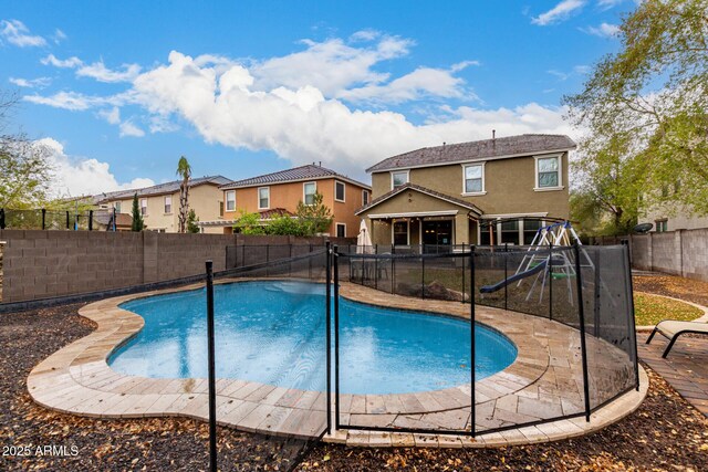 view of swimming pool with a fenced backyard, a patio area, and a fenced in pool