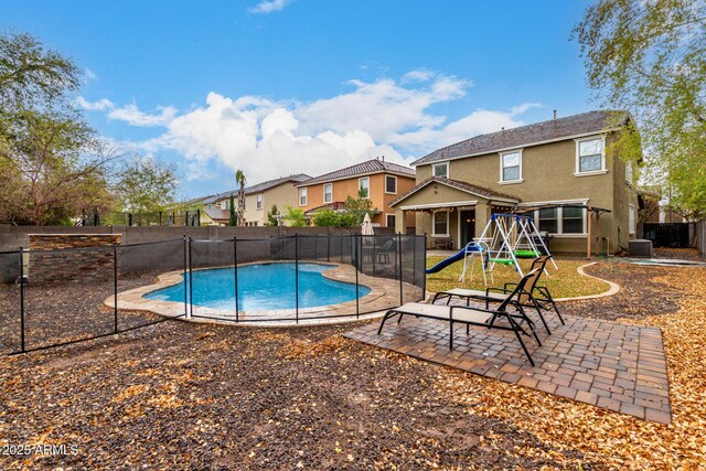 view of swimming pool with central AC, fence, a patio area, and a fenced in pool