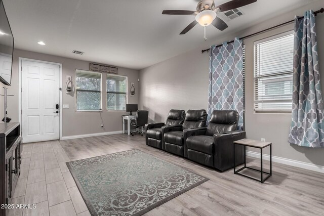 living room with ceiling fan, baseboards, light wood finished floors, and visible vents