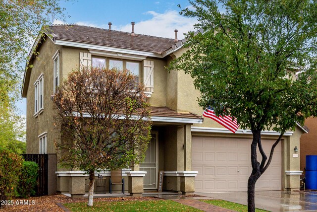 view of front of house featuring concrete driveway and stucco siding