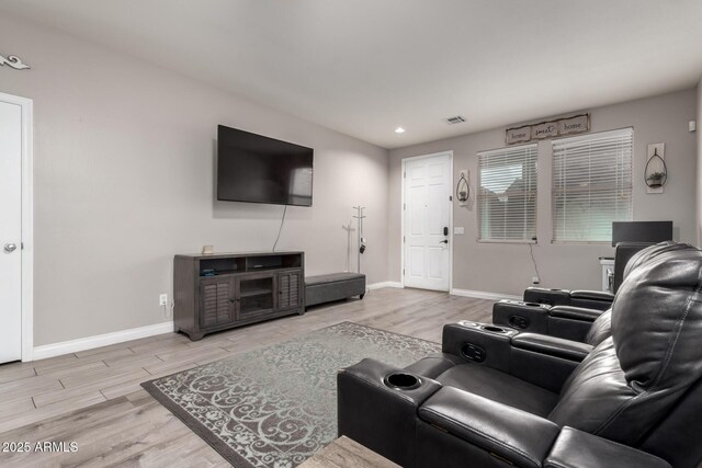 living area featuring baseboards, wood finished floors, visible vents, and recessed lighting