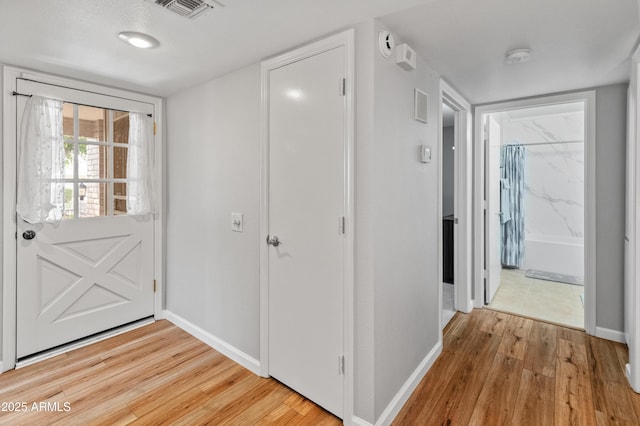 interior space featuring wood finished floors, visible vents, and baseboards