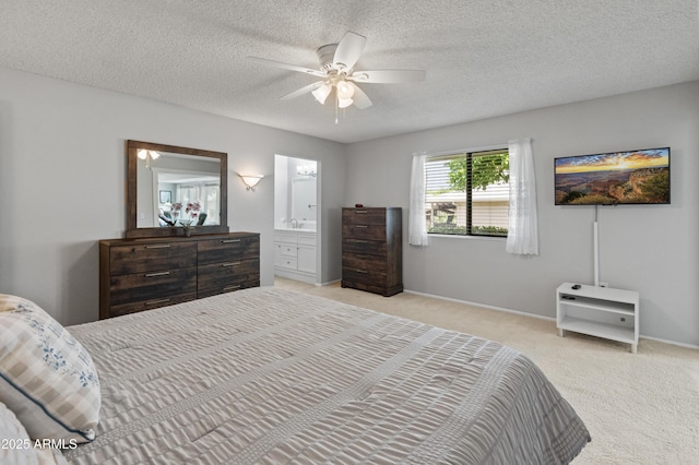 bedroom featuring light carpet, a textured ceiling, baseboards, ceiling fan, and connected bathroom
