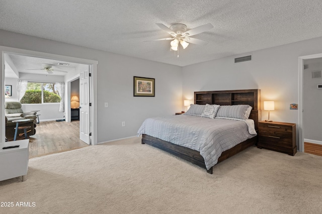 carpeted bedroom with visible vents, a ceiling fan, and baseboards