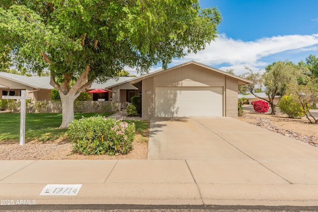 ranch-style home featuring concrete driveway, brick siding, a front yard, and a garage