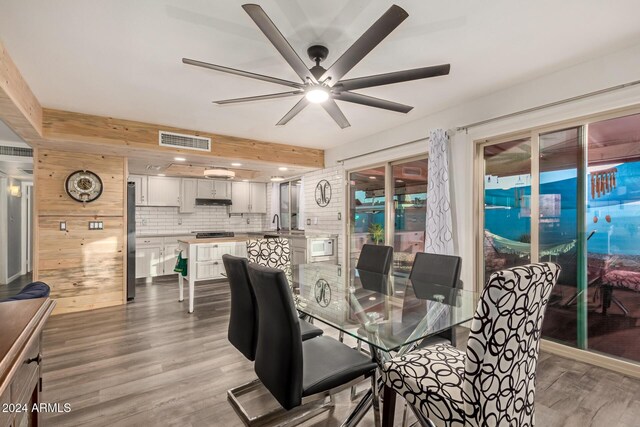 dining room featuring ceiling fan, visible vents, and wood finished floors