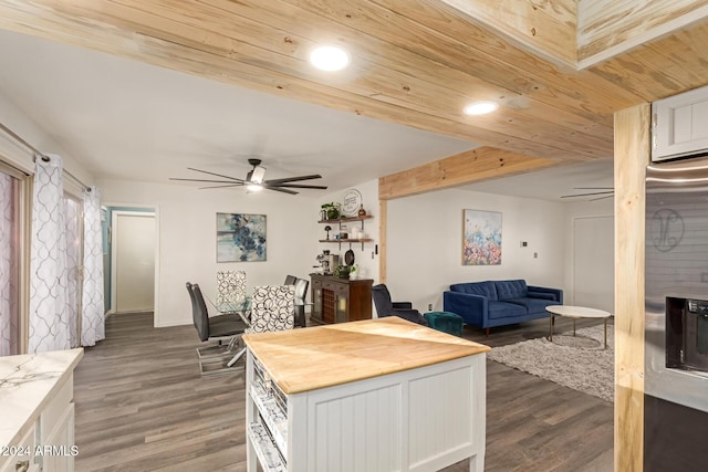 kitchen with open floor plan, wood finished floors, a ceiling fan, and white cabinets