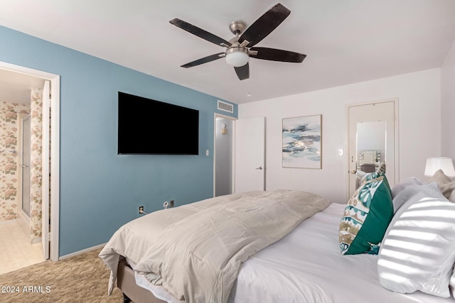 carpeted bedroom featuring visible vents, ceiling fan, and ensuite bathroom