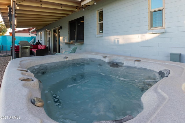 view of pool with a hot tub