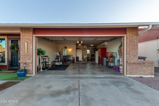 garage featuring concrete driveway