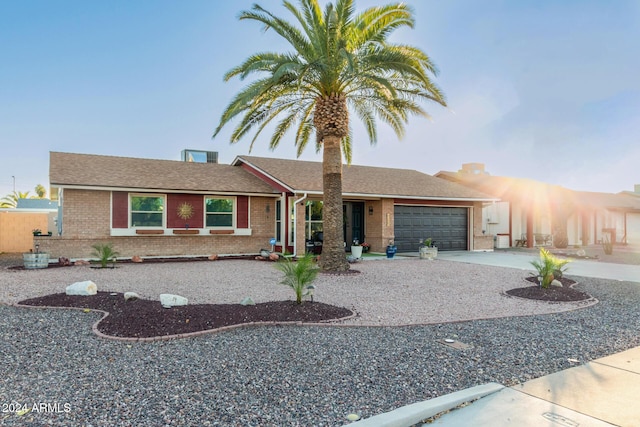 view of front of property with a garage, concrete driveway, and brick siding