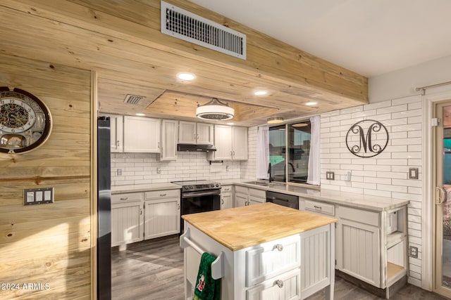 kitchen with a center island, visible vents, white cabinetry, under cabinet range hood, and black appliances