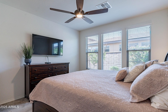 bedroom featuring a ceiling fan, baseboards, visible vents, and carpet