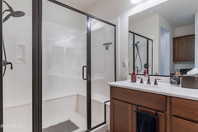 full bathroom with vanity and a shower stall
