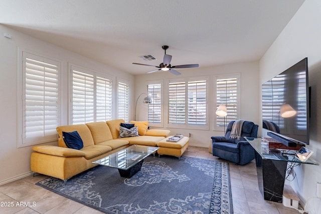 living room with visible vents, baseboards, ceiling fan, and tile patterned floors