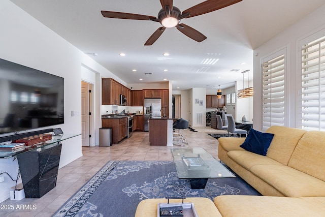 living area with light tile patterned floors, baseboards, ceiling fan, and recessed lighting