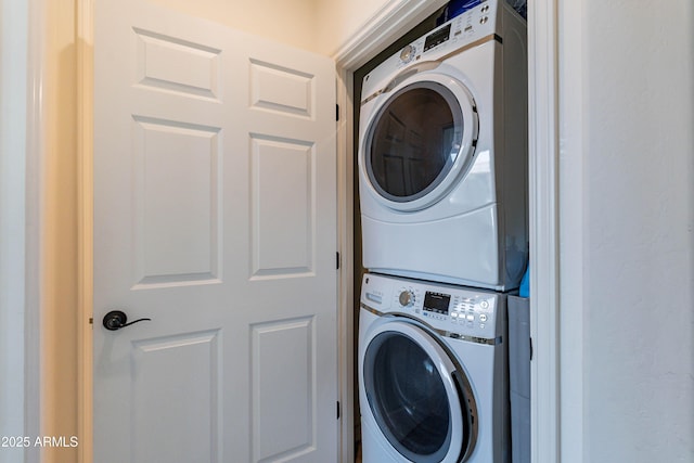 laundry area featuring laundry area and stacked washer / dryer