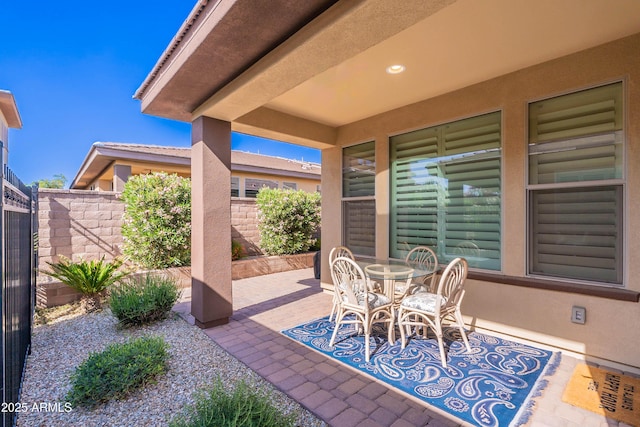 view of patio featuring fence and outdoor dining space