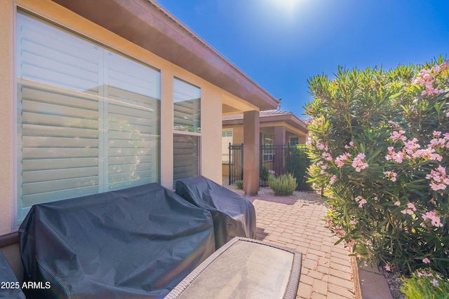 view of patio / terrace with grilling area and fence
