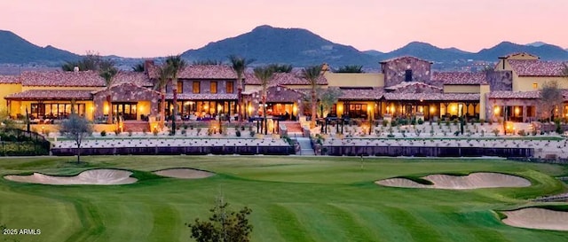 view of community with view of golf course and a mountain view