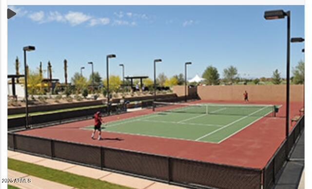 view of sport court featuring fence