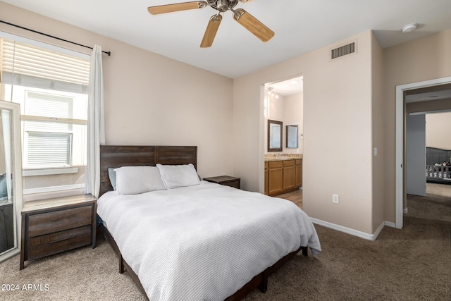 carpeted bedroom with ceiling fan and connected bathroom