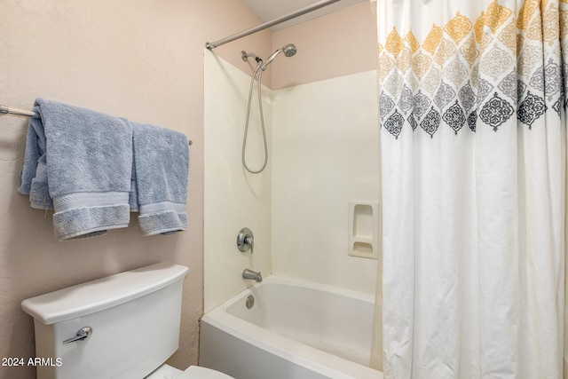 bathroom with shower / bath combo with shower curtain and toilet