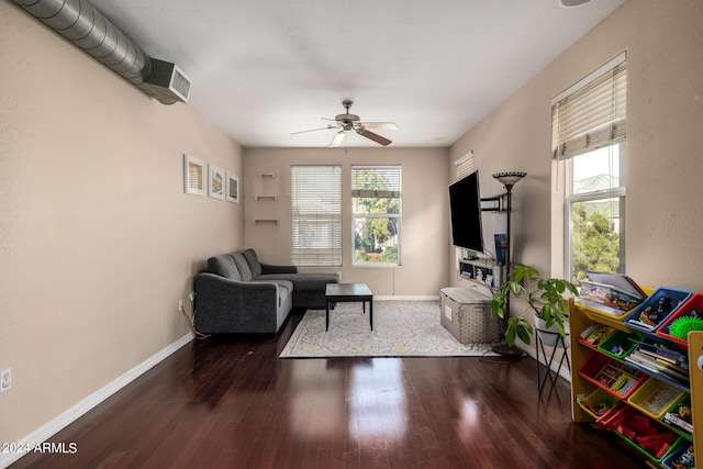 living room with ceiling fan and dark hardwood / wood-style floors