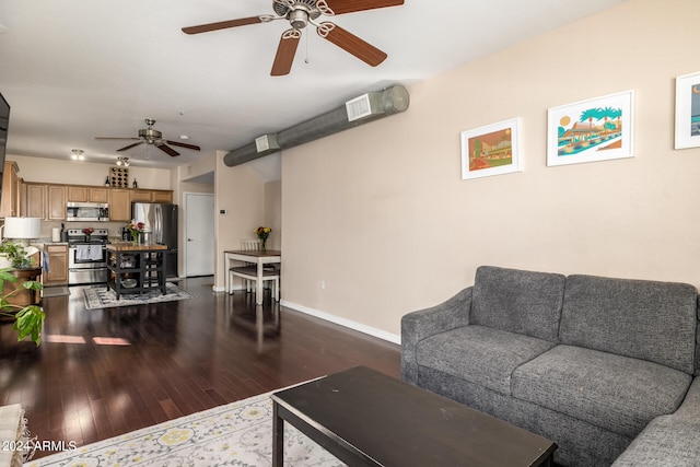 living room with ceiling fan and dark hardwood / wood-style flooring