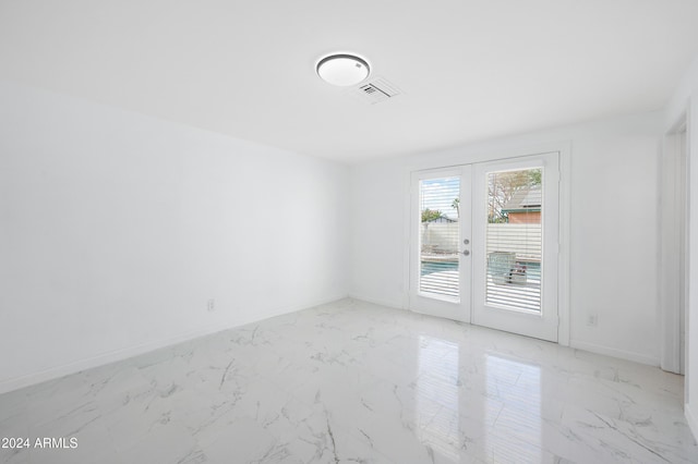 spare room featuring french doors