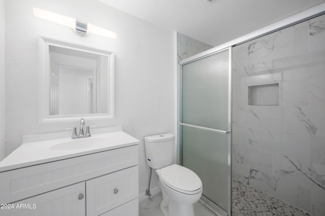 bathroom with vanity, toilet, and walk in shower