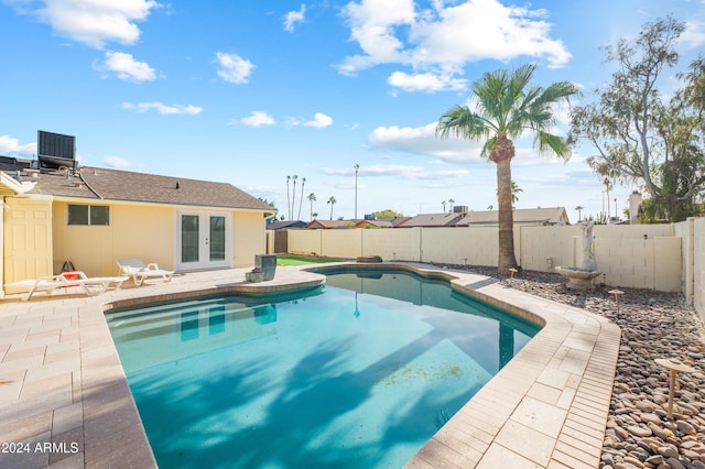 view of pool featuring a patio and french doors