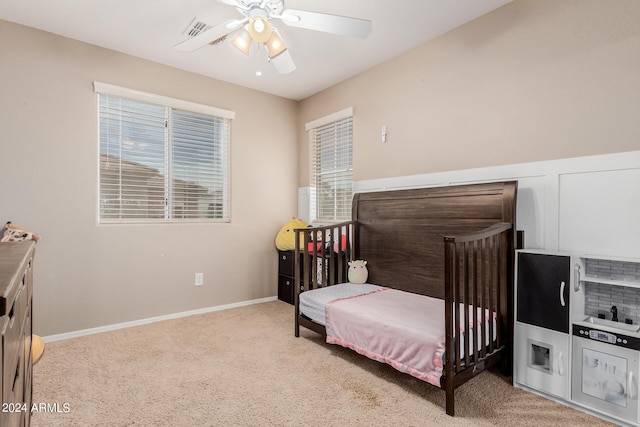 bedroom with light colored carpet and ceiling fan