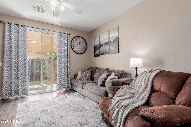 living room with hardwood / wood-style flooring and ceiling fan