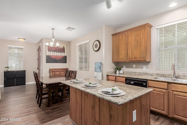 kitchen with black dishwasher, dark hardwood / wood-style flooring, sink, and a center island