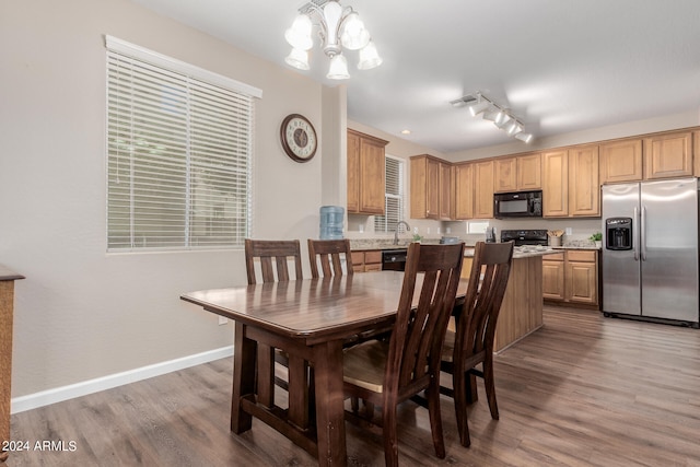 dining area with an inviting chandelier and hardwood / wood-style floors