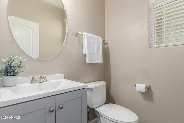 bathroom featuring toilet and vanity