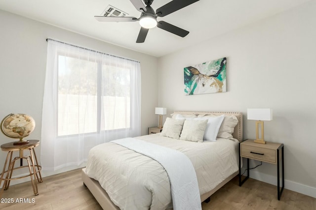 bedroom with ceiling fan and light hardwood / wood-style flooring