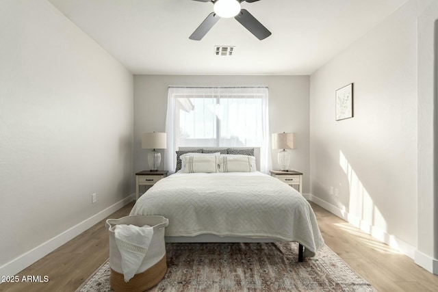 bedroom with light wood-type flooring and ceiling fan