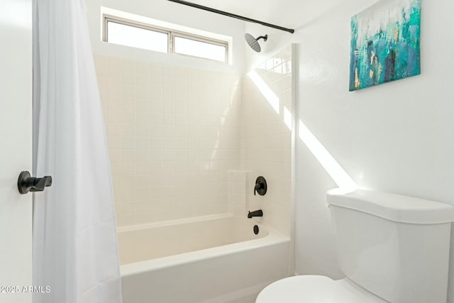 bathroom with shower / tub combo and toilet