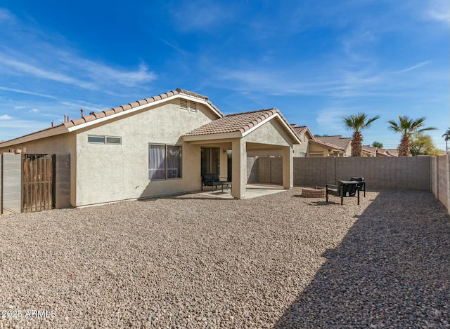 rear view of property featuring a patio area