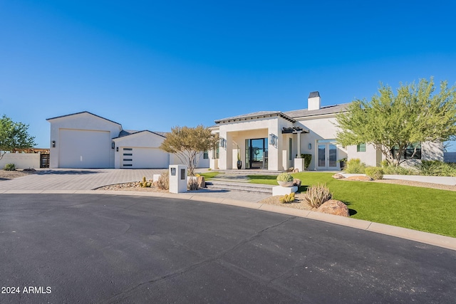 view of front facade with a front yard and a garage