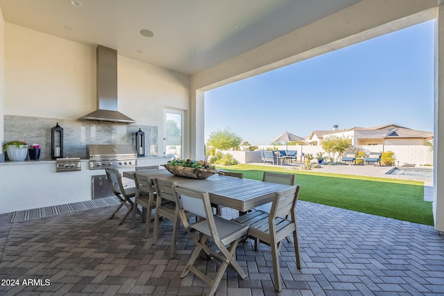 view of patio / terrace with exterior kitchen and a grill