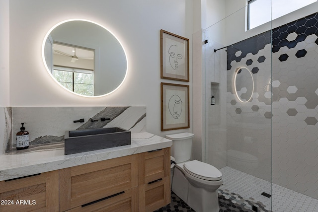 bathroom featuring toilet, an enclosed shower, and vanity