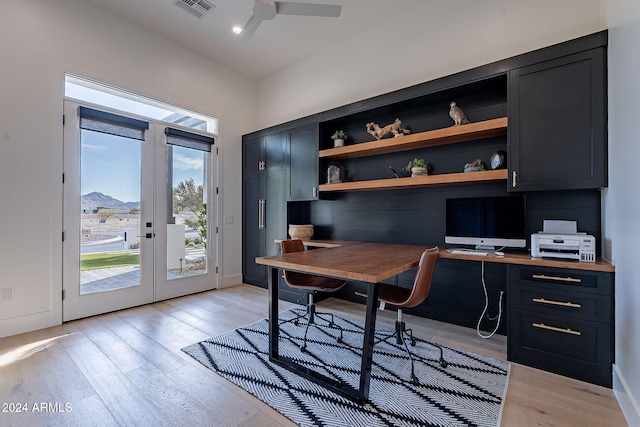 office featuring light hardwood / wood-style floors, french doors, a mountain view, and ceiling fan