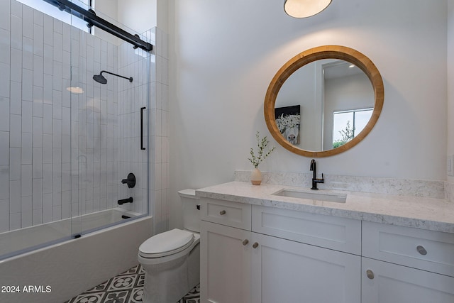 full bathroom with toilet, enclosed tub / shower combo, and vanity